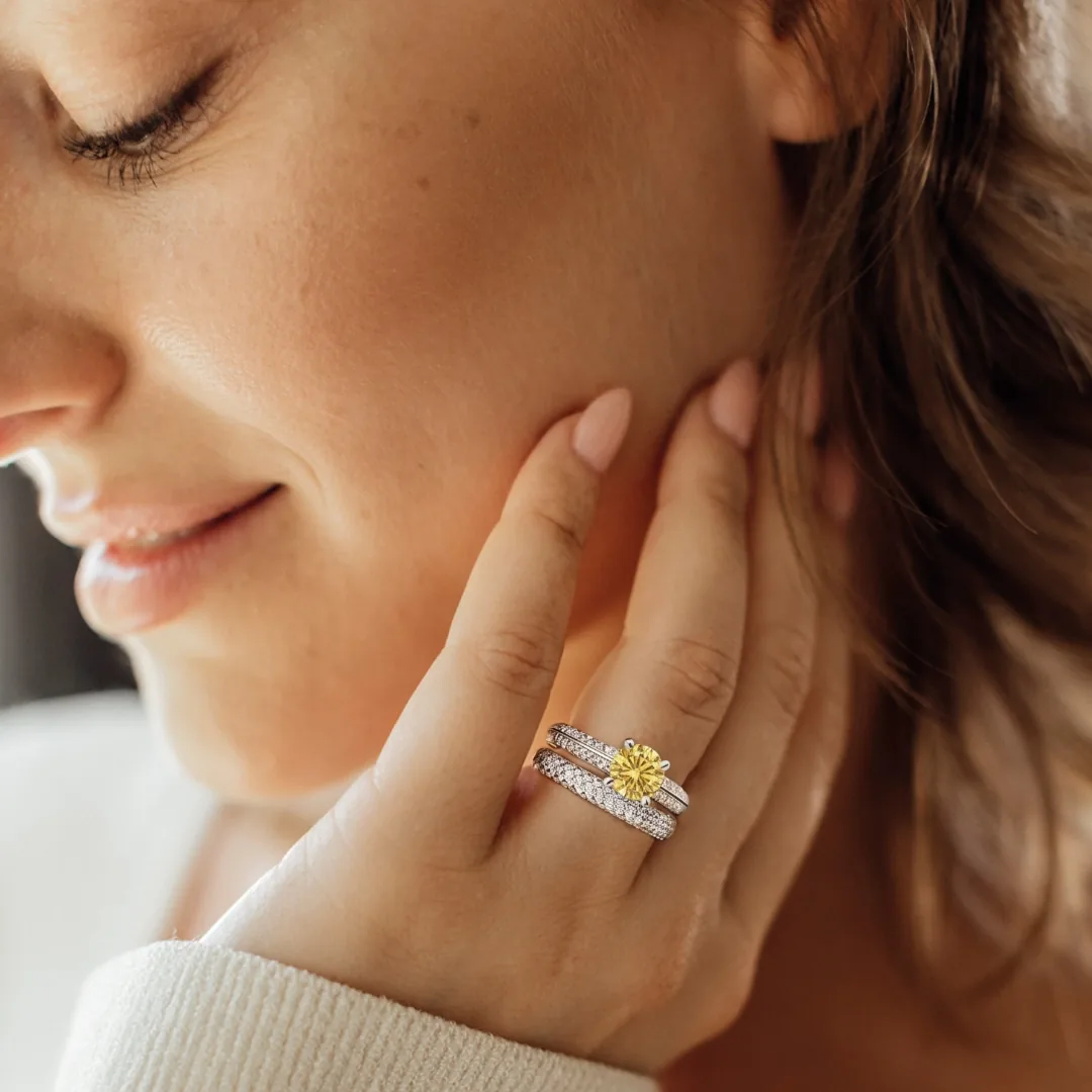RAUSCHMAYER engagement ring worn stacked with a band