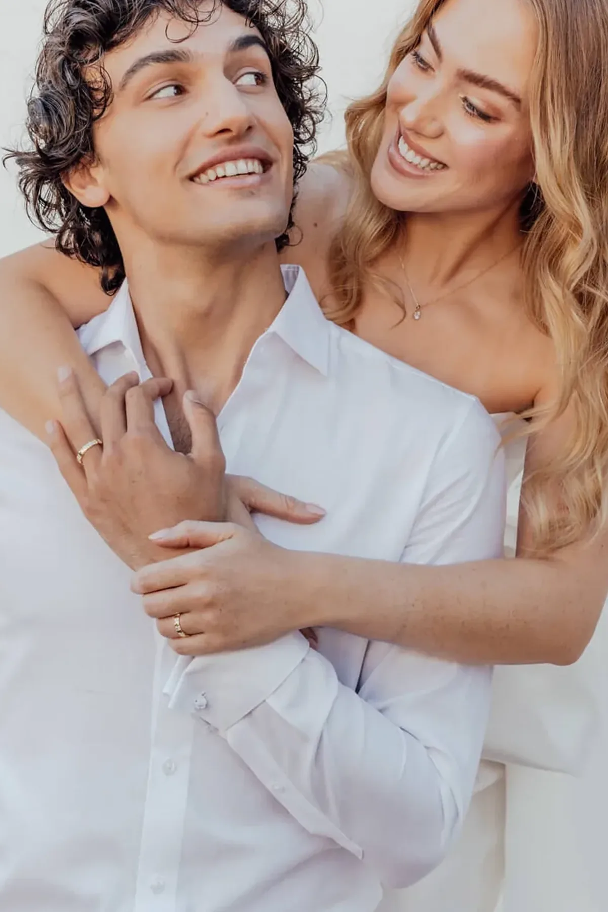 A couple wearing their RAUSCHMAYER wedding bands